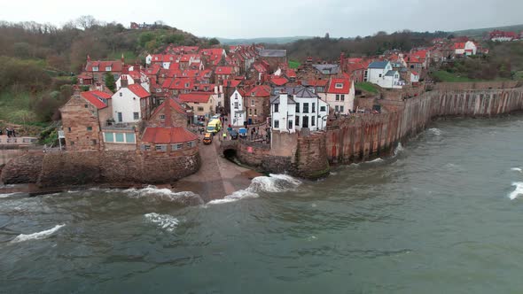 Scenic Robin's hood bay landmark village rooftops aerial view at high tide