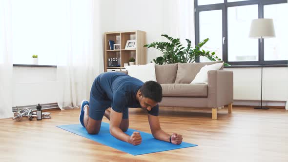 Man with Fitness Tracker Doing Plank at Home