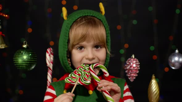 Child Kid Girl Christmas Elf Santa Claus Helper Costume Licking Candy Lollipop Caramel Sweets