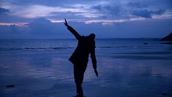 Carefree man dancing at beach