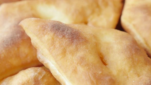 Close-up of golden pirozhki made of dough 3840X2160 UltraHD tilting footage - Fried buns served on p