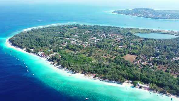 Aerial view scenery of tranquil coastline beach journey by transparent water with white sandy backgr