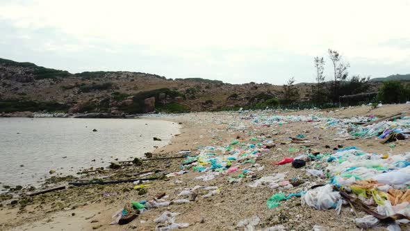 Ground level view of polluted beach in Ninh Thuan, full of plastic bags. Nature violated. Vietnam. F