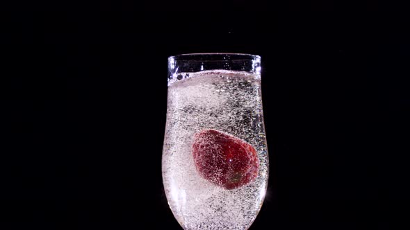 Strawberry Splash in a Champagne Flute. Slow Motion. Close Up. alt