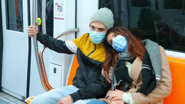 covid19, pandemic - young couple wearing mask on subway