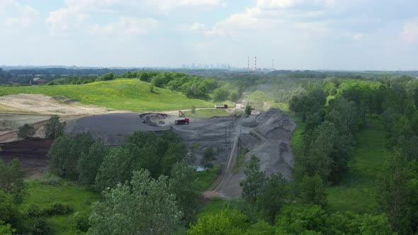 Aerial view loading bulldozer in open air quarry