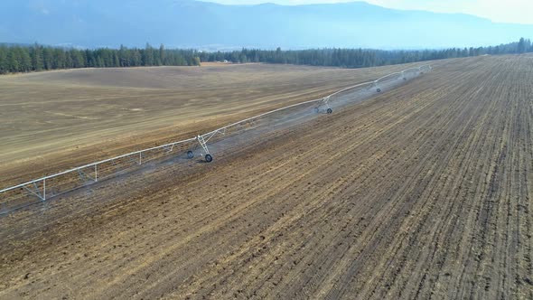 Aerial view of irrigation sprinkles used in harvested field 