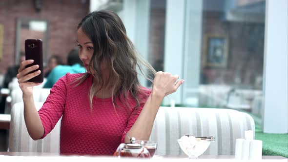 Very Beautiful Asian Young Woman Taking Selfie in Cafe