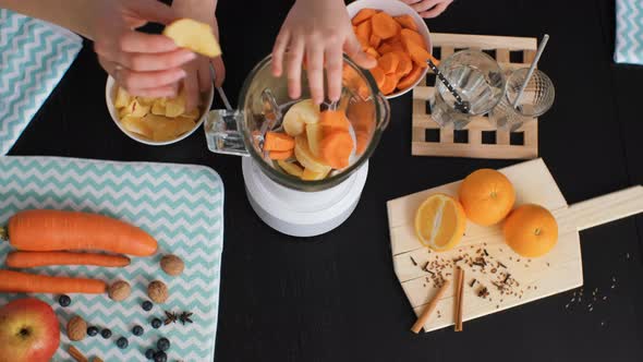 Top View of Woman with Daughter Cooking Smoothie