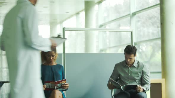 Doctor greeting nervous patient in waiting room