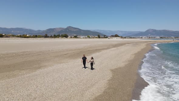 Hand In Hand On The Beach