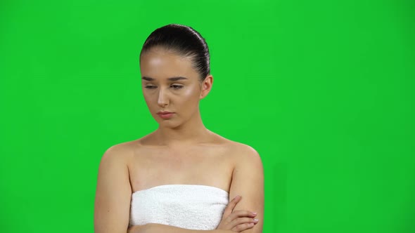 Lovely Girl in Towel Is Very Offended and Looks Away on Green Screen at Studio