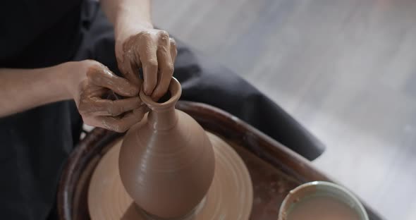 Potter Makes a Jug's Neck in Slow Motion on a Potter's Wheel Video From Pottery Workshop Potter