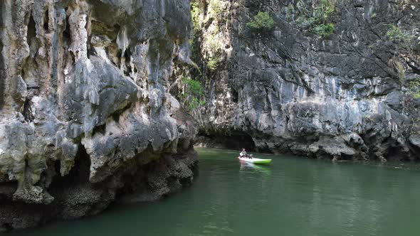a kayaker paddling on a river in Ao Thalane Krabi Thailand surrounded by limestone rocks and mountai