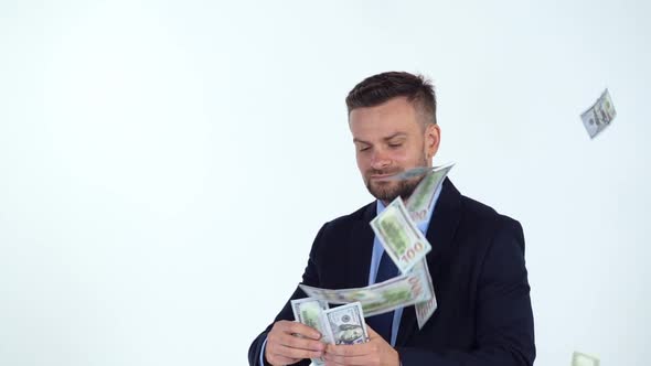 Slow Motion of Formally Dressed Man Scatters Money and a Lot of Dollar Bills are Fall on Him