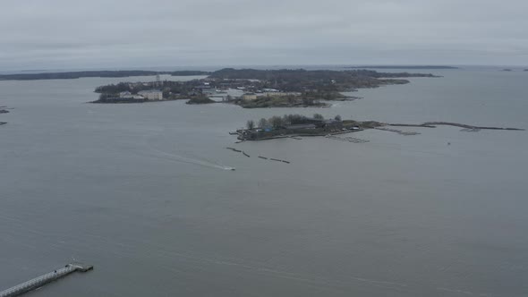 Drone view of floating boat in the sea near small islands.