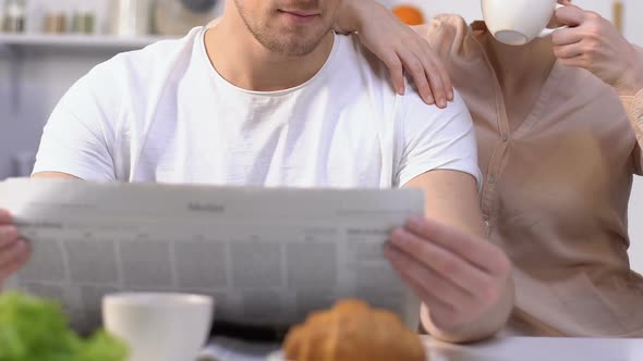 Husband Reading Morning Newspaper, Wife Drinking Coffee Admiring Life, Family