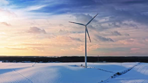 Wind turbine on snowy field, winter. Alternative energy in Poland