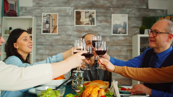 Happy Young Family Toasting with Wine Glasses