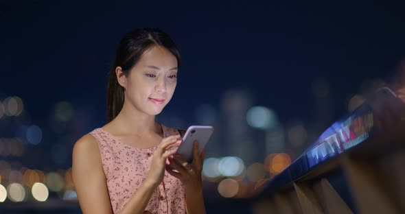 Woman use of mobile phone at night