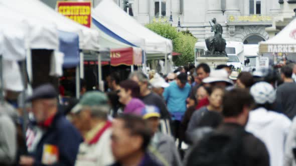 A close up, slowmotion shot of people walking through an open market in San Francisco