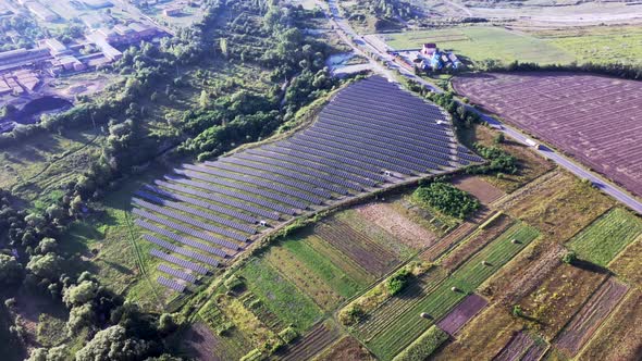 Solar panels among nature. Long rows of blue photovoltaic panels on the field