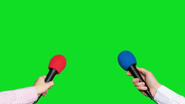 Microphones in the Hands of Journalists for Interview on Green Screen Background