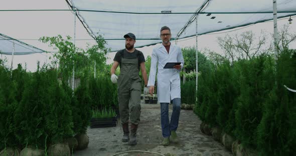 Gardeners Walking in Nursery Garden