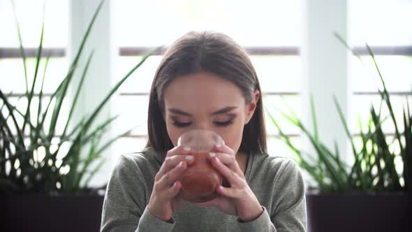 Woman On Diet Drinking Detox Smoothie Indoors