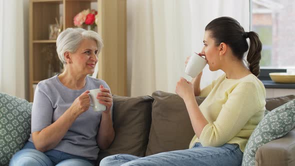 Senior Mother and Adult Daughter Drinking Coffee