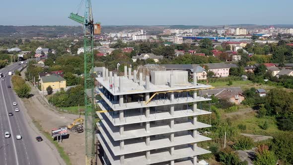 Workers work with crane and steel concrete reinforcement at large construction site