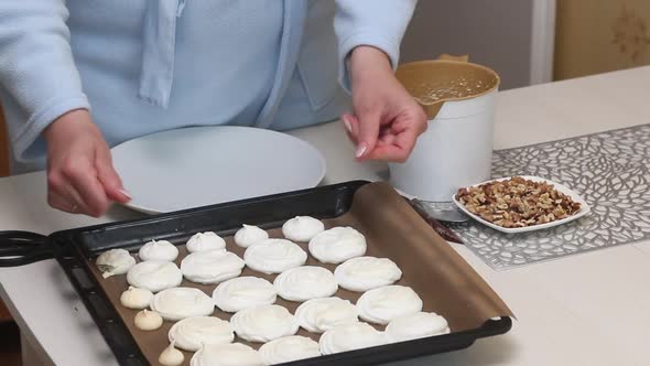 A Woman Checks The Quality Of The Meringue. Baking Tray With Meringue For Cake.