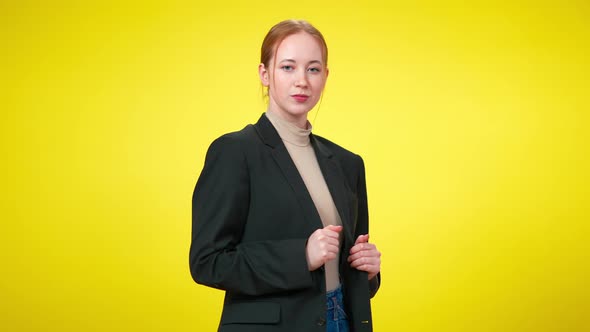 Middle Shot of Confident Sensual Young Businesswoman in Suit Flirting with Camera at Yellow