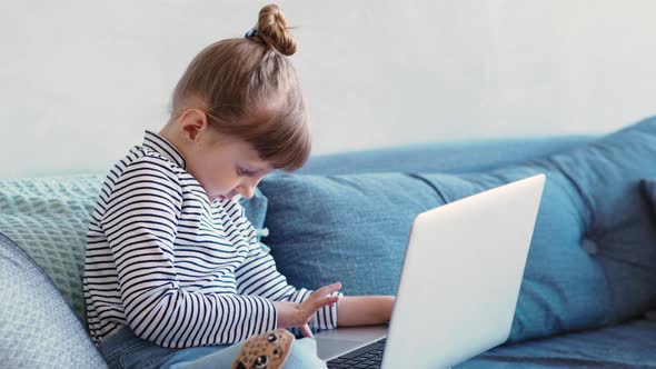 Education, School, Technology and Internet Concept - Little Student Girl with Laptop Pc