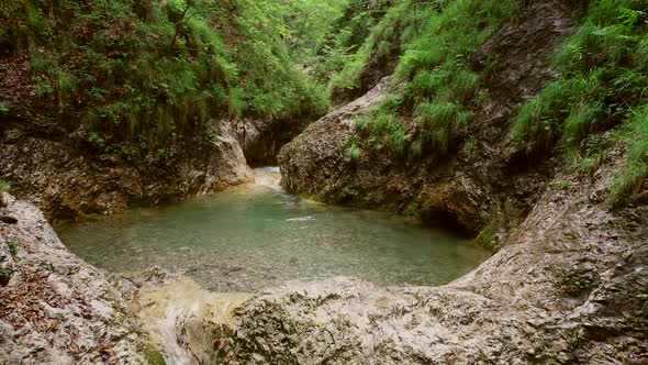 Aerial view of small waterfalls surrounded by a lot of vegetation in Soca river.