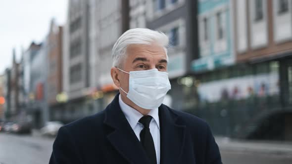 Senior Gentleman or Businessman on Street of Amsterdam in Mask Due to Covid 19