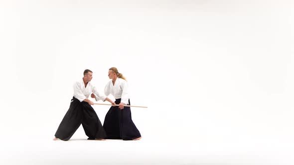 Two Guys in Kimono Performing Aikido Using Bokken