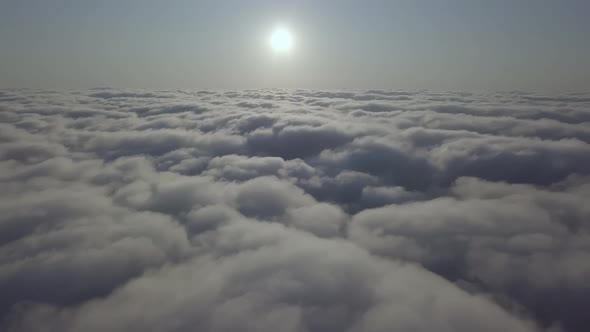 View From a Drone on a Sea of Clouds to the Horizon at Dawn