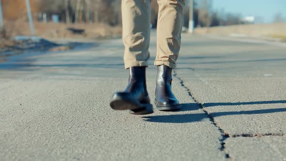 Man Legs Walking.Businessman Legs On Sneakers Relaxing.Lonely Handsome Man In Leather Shoes On Road.