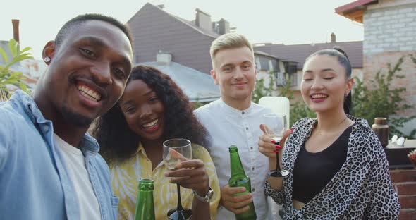 Friends Making Selfie During Party on the Terrace Overlooking at City Roofs at Summertime