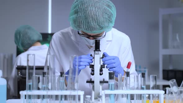 Researcher doctor in PPE work in laboratory room of covid-19 vaccine and drug manufacturing company.