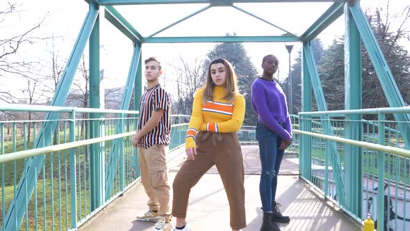 slow motion shot of friends posing on a bridge