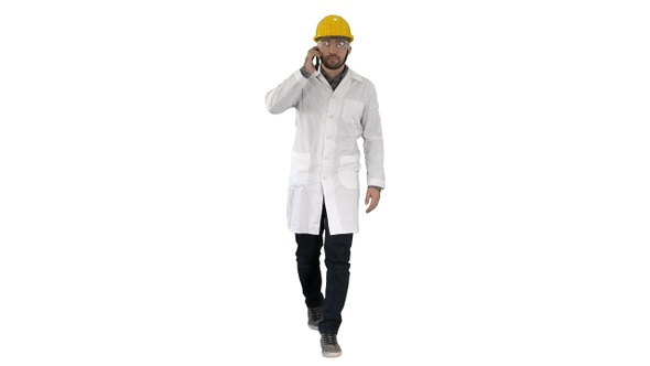 Confident Male Engineer Wearing Helmet on Call on White Background