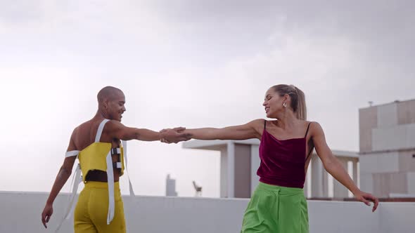 Dancers In Clubwear Dancing Together On Skyscraper