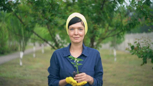 Brunette Female with Plant Outdoors