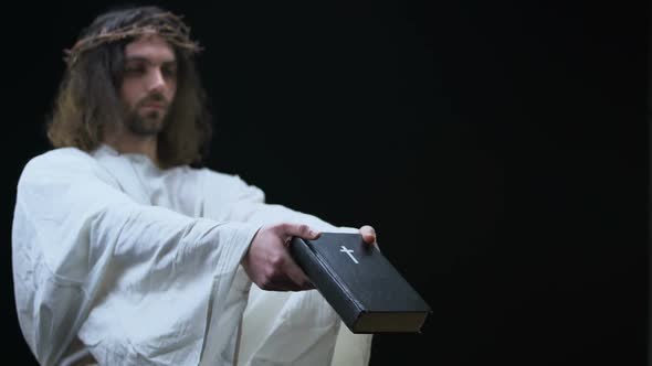 Messiah Giving Bible to Man on Dark Background, Holy Scripture, Religious Help