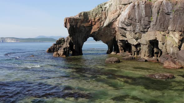 Drone View of a Natural Stone Arch By the Sea