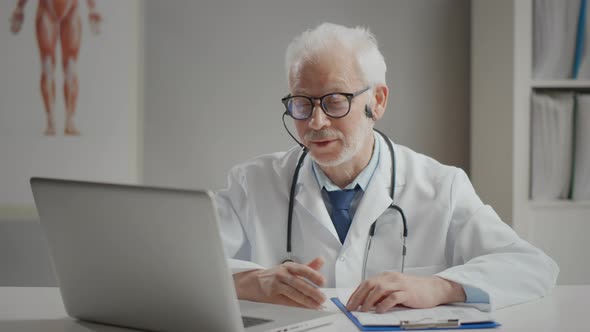 Elderly Doctor Consulting Patient Online Because of Epidemic