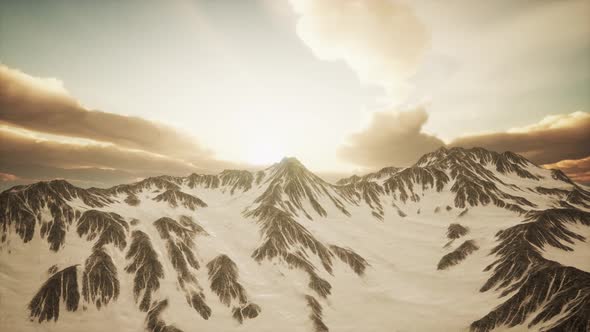 Panorama of High Snow Mountains at Sunset