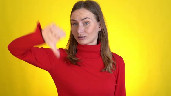 Dissatisfied Puzzled Confused Young Woman Posing Isolated on Yellow Background Studio